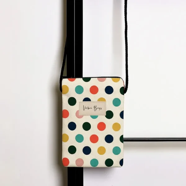 Bolso mini porta móvil bandolera con estampado de lunares de colores con fondo blanco